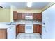 Well-lit kitchen featuring matching appliances and backsplash on tile flooring at 6255 Osprey Lake Cir, Riverview, FL 33578