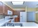 Well-lit kitchen featuring wooden cabinetry, modern appliances, and tile backsplash at 6255 Osprey Lake Cir, Riverview, FL 33578