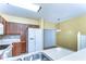 Bright kitchen with wooden cabinets, white appliances, and a dining area with sliding glass doors at 6255 Osprey Lake Cir, Riverview, FL 33578