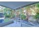 Enclosed patio with tile flooring, offering a private and scenic view of the backyard oasis at 6255 Osprey Lake Cir, Riverview, FL 33578