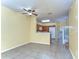 Open floor plan featuring a spacious living room with a ceiling fan and tile floors at 6255 Osprey Lake Cir, Riverview, FL 33578