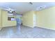 Open-concept living space with tile flooring and ample natural light showcases a versatile and inviting atmosphere at 6255 Osprey Lake Cir, Riverview, FL 33578