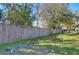 Community playground features a swing set and seesaw in a fenced green space with mature trees at 6255 Osprey Lake Cir, Riverview, FL 33578
