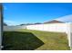 Spacious backyard features well-maintained lawn and a tall white vinyl fence at 6863 Hanworth Ln, Zephyrhills, FL 33541
