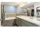 Bathroom with a soaking tub, a walk-in shower, and a double sink vanity at 6863 Hanworth Ln, Zephyrhills, FL 33541