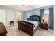 Spacious bedroom with a queen bed, blue wall, and carpeted floor at 6863 Hanworth Ln, Zephyrhills, FL 33541