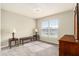 Bright bedroom filled with natural light from a large window plus two dark wood accent tables at 6863 Hanworth Ln, Zephyrhills, FL 33541