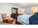 Bedroom with a queen bed, carpeted floor, and access to an attached bathroom at 6863 Hanworth Ln, Zephyrhills, FL 33541