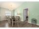 Chandelier in the dining area with seating for six in an open floor plan at 6863 Hanworth Ln, Zephyrhills, FL 33541