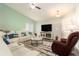 Bright living room with modern furniture and a television at 6863 Hanworth Ln, Zephyrhills, FL 33541