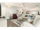 Comfortable living room featuring a sectional sofa, area rug, and stylish decor at 6863 Hanworth Ln, Zephyrhills, FL 33541