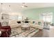 Spacious living room with a sectional sofa and access to the lanai at 6863 Hanworth Ln, Zephyrhills, FL 33541