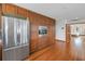 Kitchen area featuring stainless steel refrigerator and lots of cabinets with hardwood floors at 73 Sunset Ln, Terra Ceia, FL 34250