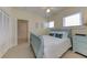 Cozy bedroom with a blue bed frame, white bedding, bright light, and a large closet at 820 Druid S Rd, Clearwater, FL 33756