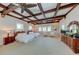 Spacious bedroom featuring coffered ceiling, neutral carpet, and sunny windows with two twin beds and sitting area at 820 Druid S Rd, Clearwater, FL 33756
