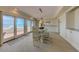 Bright dining area with glass table and water views, adjacent to the kitchen and waterfront balcony at 820 Druid S Rd, Clearwater, FL 33756