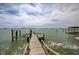 Private wooden dock on the water offers direct access to waterfront activities and stunning views at 820 Druid S Rd, Clearwater, FL 33756