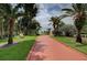 Estate featuring a red brick driveway lined with mature trees at 820 Druid S Rd, Clearwater, FL 33756