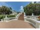 Outdoor stairway ascends to the home, framed by elegant white railings and manicured greenery at 820 Druid S Rd, Clearwater, FL 33756