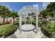 Exterior view of a beautiful gazebo, landscaped with palm trees and manicured lawn at 820 Druid S Rd, Clearwater, FL 33756