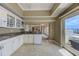 Bright kitchen featuring granite countertops, white cabinetry, and balcony access at 820 Druid S Rd, Clearwater, FL 33756