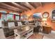 Cozy living room with warm orange walls, exposed beam ceiling, and comfortable seating at 8390 39Th N Ave, St Petersburg, FL 33709