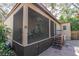 Exterior view of screened in porch with furniture and door access; stairs to the backyard at 8390 39Th N Ave, St Petersburg, FL 33709