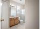 Well-lit bathroom with a wooden vanity and tiled floors at 9224 Lost Mill Dr, Land O Lakes, FL 34638