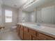 Bathroom with light wood vanity, neutral countertops, and tiled floors at 9224 Lost Mill Dr, Land O Lakes, FL 34638