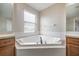 Bright bathroom with a corner tub and vanity, creating a relaxing atmosphere at 9224 Lost Mill Dr, Land O Lakes, FL 34638