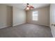 Bedroom featuring carpet, a ceiling fan, and a window with bright natural light at 9224 Lost Mill Dr, Land O Lakes, FL 34638