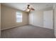 This bedroom features a ceiling fan and large window for ample natural light at 9224 Lost Mill Dr, Land O Lakes, FL 34638