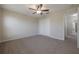 Bedroom featuring plush carpeting, a ceiling fan, and a double door closet at 9224 Lost Mill Dr, Land O Lakes, FL 34638