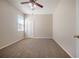This bedroom has a ceiling fan, plush carpet, and large window at 9224 Lost Mill Dr, Land O Lakes, FL 34638