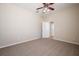 Neutral bedroom with carpet, ceiling fan, and access to an adjacent room at 9224 Lost Mill Dr, Land O Lakes, FL 34638