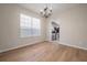 Dining room with a decorative chandelier, hardwood floors, and window views at 9224 Lost Mill Dr, Land O Lakes, FL 34638
