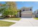 Two-story home boasts a two-car garage, well-maintained lawn, and welcoming curb appeal at 9224 Lost Mill Dr, Land O Lakes, FL 34638