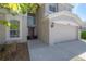 Close up of the home's front door and an attached two-car garage at 9224 Lost Mill Dr, Land O Lakes, FL 34638