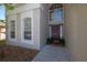Close up of the home's front door with decorative window and green landscape at 9224 Lost Mill Dr, Land O Lakes, FL 34638