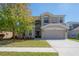 Charming two-story home featuring an attached two-car garage and a beautifully landscaped front yard at 9224 Lost Mill Dr, Land O Lakes, FL 34638