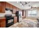 A well-lit kitchen with stainless steel refrigerator and black oven range at 9224 Lost Mill Dr, Land O Lakes, FL 34638