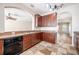 Spacious kitchen with granite countertops, wood cabinets, and stone tile flooring at 9224 Lost Mill Dr, Land O Lakes, FL 34638