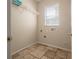 Functional laundry room with tile floors and a window for natural light at 9224 Lost Mill Dr, Land O Lakes, FL 34638