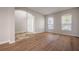 Spacious living room with hardwood floors and an arched entryway at 9224 Lost Mill Dr, Land O Lakes, FL 34638