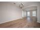 Bright living room featuring hardwood floors, chandelier, and arched entryway at 9224 Lost Mill Dr, Land O Lakes, FL 34638