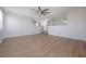 Spacious living room featuring hardwood floors, a ceiling fan, and steps to the second floor at 9224 Lost Mill Dr, Land O Lakes, FL 34638