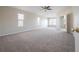 Large main bedroom with carpet and windows, leading to the en-suite bathroom at 9224 Lost Mill Dr, Land O Lakes, FL 34638
