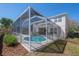 Exterior view of home featuring enclosed pool, screened-in lanai, and manicured lawn at 9224 Lost Mill Dr, Land O Lakes, FL 34638