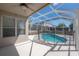 Covered patio featuring enclosed pool with safety fence and screened-in lanai at 9224 Lost Mill Dr, Land O Lakes, FL 34638