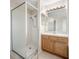 Bathroom shower with glass doors and wooden cabinets, offering a functional space at 9224 Lost Mill Dr, Land O Lakes, FL 34638